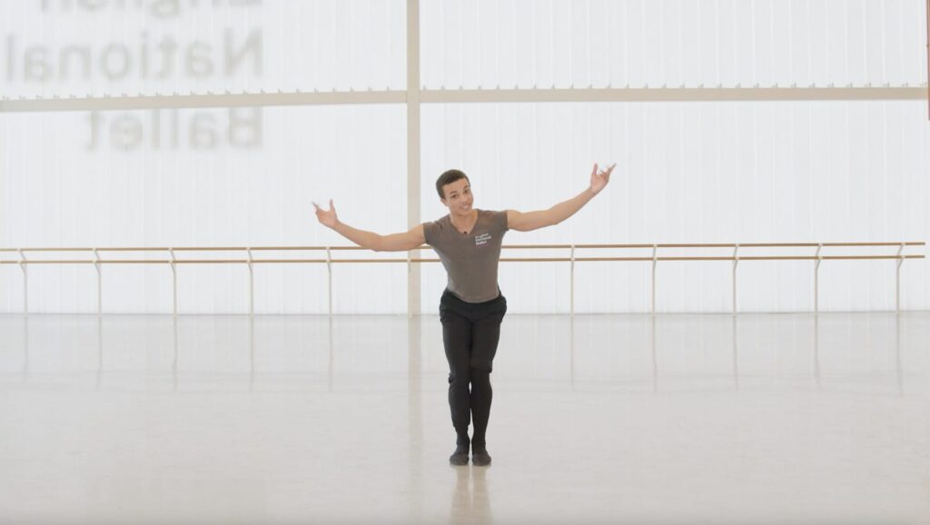 A male ballet dancer takes a bow in a spacious